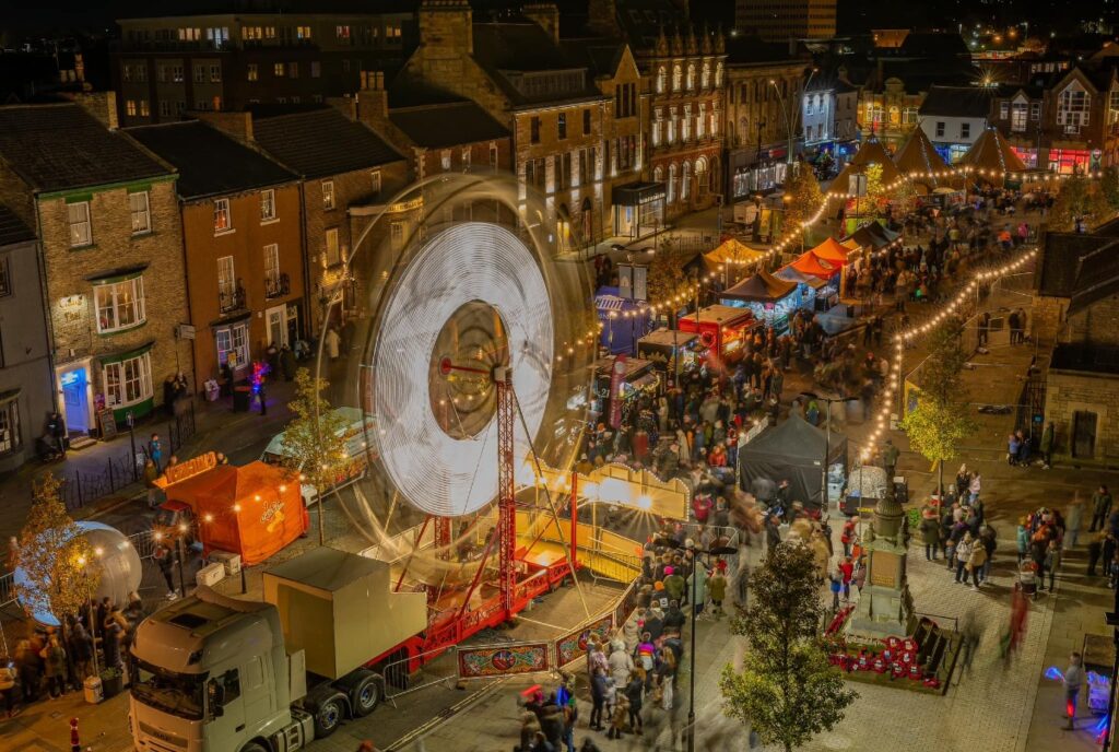 Bishop Auckland Christmas Town 2023 in Bishop Auckland Market Place. Ferris Wheel and Market Stalls.